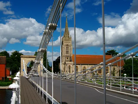 Marlow suspension bridge and All Saints church beside the River Thames.