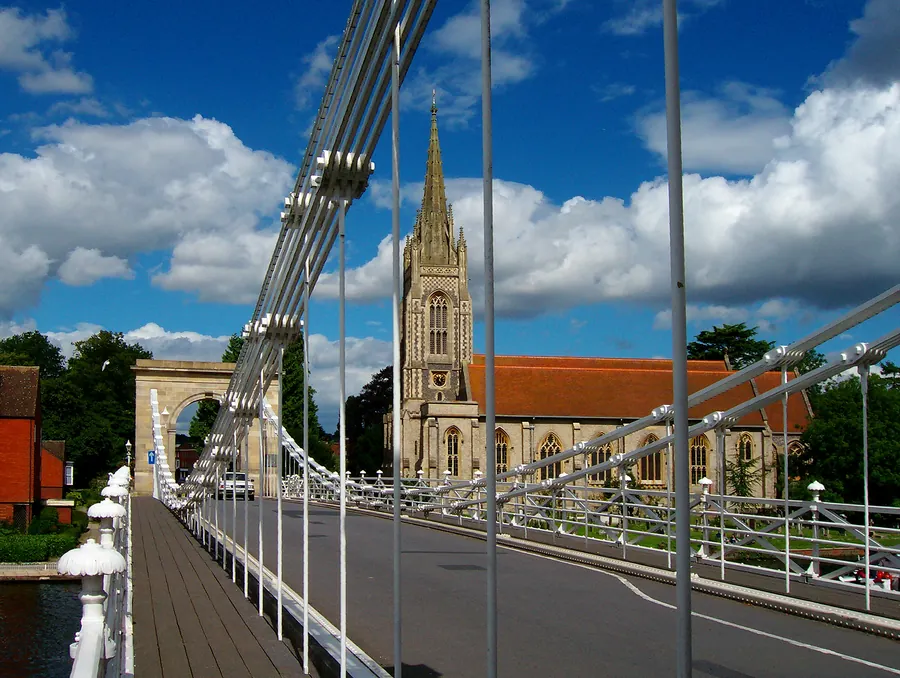 Marlow suspension bridge and All Saints church beside the River Thames.
